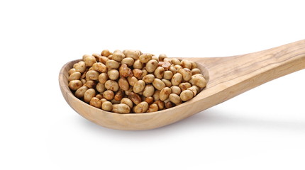 Organic roasted soybean flakes in wooden spoon isolated on white background