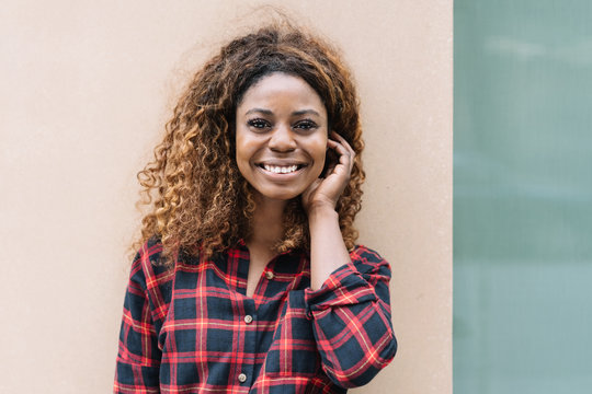Young smiling black woman wearing checked shirt