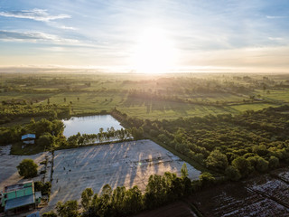 Beautiful aerial view of sunrise above the paddy fields at Northern Thailand. Aerial view from flying drone. Amazing nature landscape.