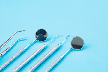 Dental tools use for dentist on the blue background, flat lay, top vipw.