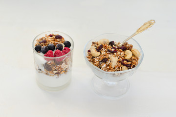 Granola with berries and yogurt on a white background. Traditional American Breakfast