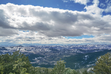 Fototapeta premium Mountain view valley on snow winter day with cloudy dark and blue sky