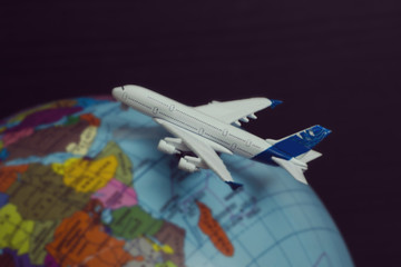 Fototapeta na wymiar Airplane on the globe. Travel concept. Close up