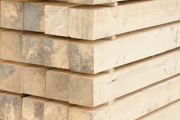 Wooden beams stacked in a pile. Close-up