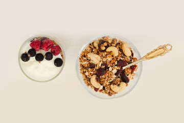 Granola with berries and yogurt on a white background. Traditional American Breakfast