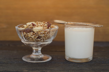 Granola with berries and yogurt on a wooden table. Side view. Traditional American Breakfast