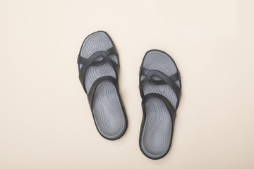 Beach slates on beige background. Beach wardrobe. Fashionable concept