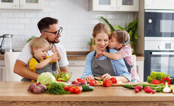 appy family with child  preparing vegetable salad