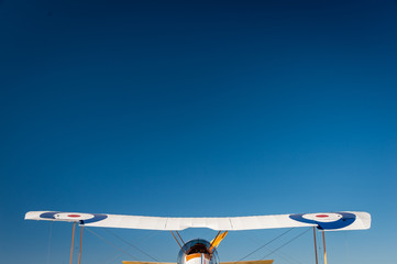 Wing span of a WWI biplane against blue sky