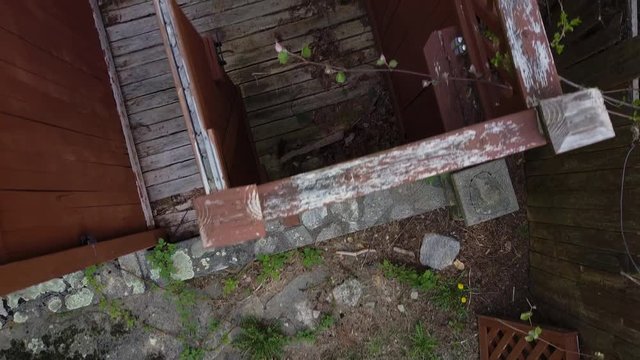 Aerial dolly over the remains of an outdoor shower in disrepair