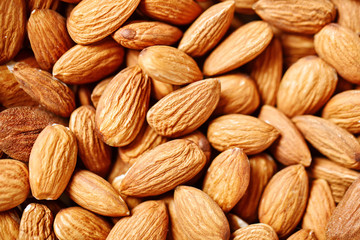 Almond on a wooden table in the summer garden. Useful food. Healthy lifestyle.