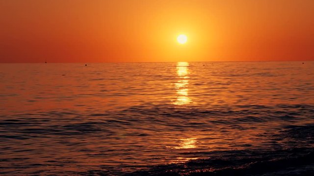 Colorful landscape, sunset on the beach.Endless horizon, the reflection of the sun's rays on the waves of the sea.