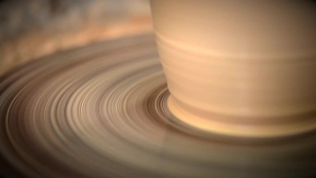 Vase from fresh clay turn twirl potter's wheel. Sculptor in workshop makes jug out of clay closeup. Master crock. Potter's work close-up. Workshop pottery. Handmade. Craft. Traditions. Seamless loop