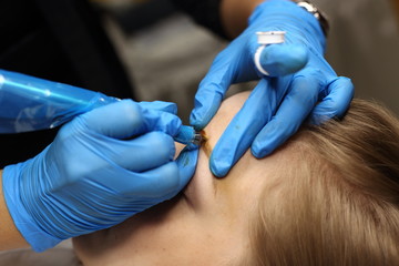 applying Tottoo, Brow Microblading to customer eyebrows