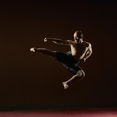 A man in a high jump beats a kick