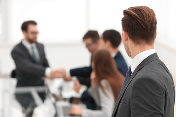 Business partners shaking hands over business objects on workpla