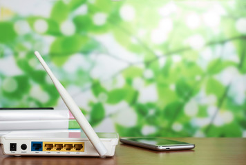 Panel with sockets for modem connection, next to smartphone on light background