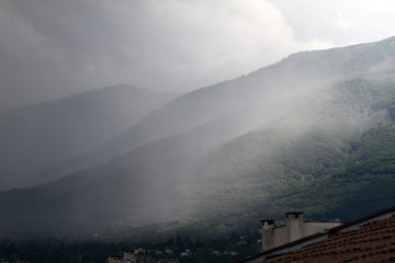 Heavy rain and a storm with damages on the Balkans in Europe. Rain and storm hail fall on the mountain. Thunder and lightning storm with rainfall. rainfall intensity. Bad weather concept. Rain shower.