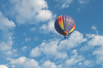 hdr shot of hot air balloons flying in blue sky with white clouds  (selective focus)