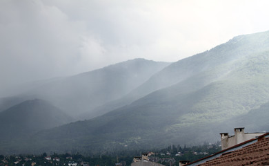 Heavy rain and a storm with damages on the Balkans in Europe. Rain and storm hail fall on the mountain. Thunder and lightning storm with rainfall. rainfall intensity. Bad weather concept. Rain shower.