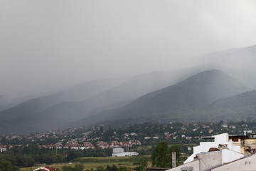 Fototapeta na wymiar Heavy rain and a storm with damages on the Balkans in Europe. Rain and storm hail fall on the mountain. Thunder and lightning storm with rainfall. rainfall intensity. Bad weather concept. Rain shower.