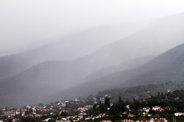 Heavy rain and a storm with damages on the Balkans in Europe. Rain and storm hail fall on the mountain. Thunder and lightning storm with rainfall. rainfall intensity. Bad weather concept. Rain shower.