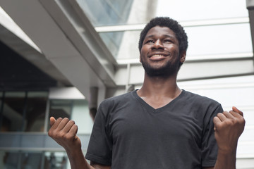 Fototapeta premium Strong successful African man portrait; happy smiling strong confident young adult african man expressing positive excited, surprised expression; African young adult man model