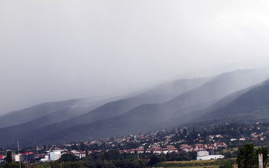 Heavy rain and a storm with damages on the Balkans in Europe. Rain and storm hail fall on the mountain. Thunder and lightning storm with rainfall. rainfall intensity. Bad weather concept. Rain shower.