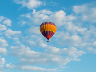 hdr shot of hot air balloons flying in blue sky with white clouds  (selective focus)