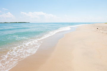 HDR shot of sea shore with wave and white sand during summer day in thailand (selective focus and white balance / color tone shift )