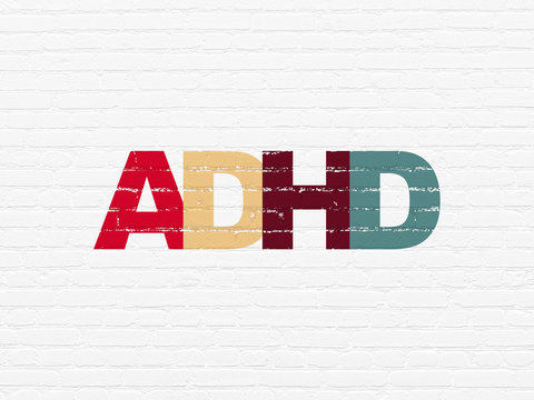 Medicine concept: Painted multicolor text ADHD on White Brick wall background