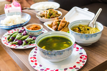 Includes a set of Thai dishes on the table.