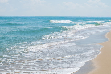 HDR shot of sea shore with wave and white sand during summer day in thailand (selective focus and white balance / color tone shift )