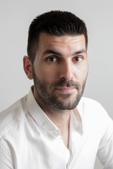 Obraz premium Portrait of young attractive bearded man, studio headshot