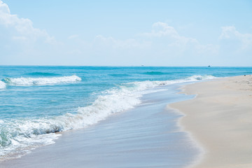 HDR shot of sea shore with wave and white sand during summer day in thailand (selective focus and white balance / color tone shift )
