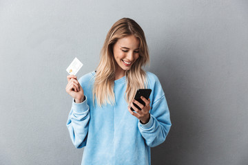 Pretty young blonde girl in blue sweatshirt