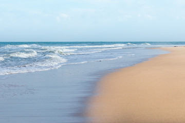 HDR shot of sea shore with wave and white sand during summer day in thailand (selective focus and white balance / color tone shift )
