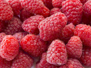 Background of raspberries. Fresh raspberries closeup. Top view. Background of red berries. Various fresh summer fruits.