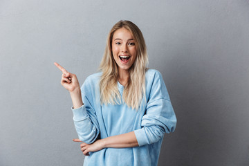 Portrait of an excited young girl in blue sweatshirt