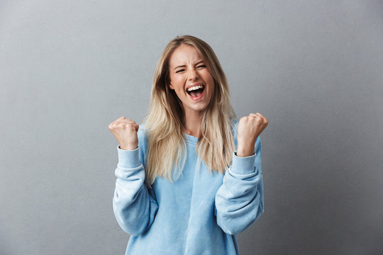 Portrait Of A Happy Young Blonde Girl Celebrating Success