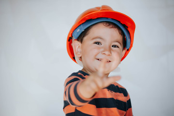 Portrait of little boy in headpiece. Concept of real estate and engineering
