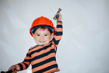 Little kid as a construction worker, hitting with a hammer