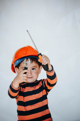 Little kid as a construction worker, hitting with a hammer