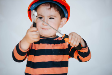 Little kid as a construction worker, hitting with a hammer