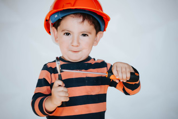 Little kid as a construction worker, hitting with a hammer