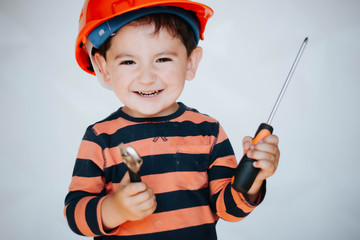 Little kid as a construction worker, hitting with a hammer