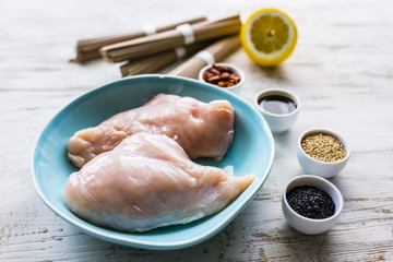 Ingredients to prepare teriyaki from chicken with soba noodles and sesame seeds.
