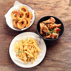 Fast food  - onion rings, fries and chicken wings