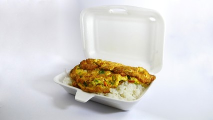 Rice omelet in a foam box on the white background.