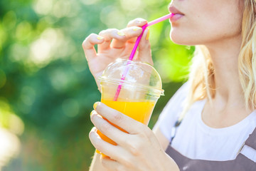 a girl drinks freshly squeezed juice, a healthy lifestyle